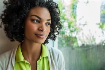 Woman looking thoughtfully out the window