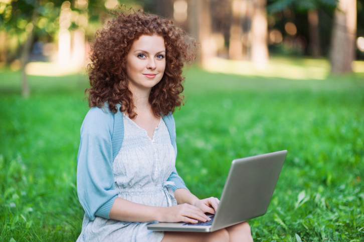 Young woman outside with laptop